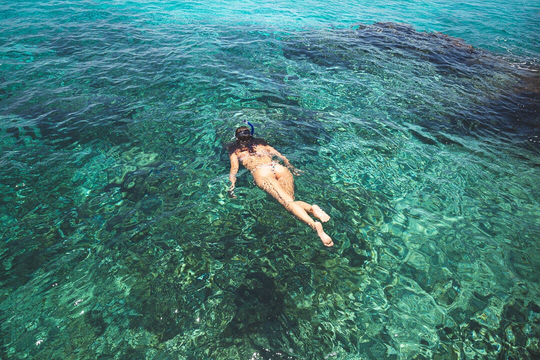 Snorkeling Cozumel A girl snorkeling in emerald water in Cozumel, Mexico.